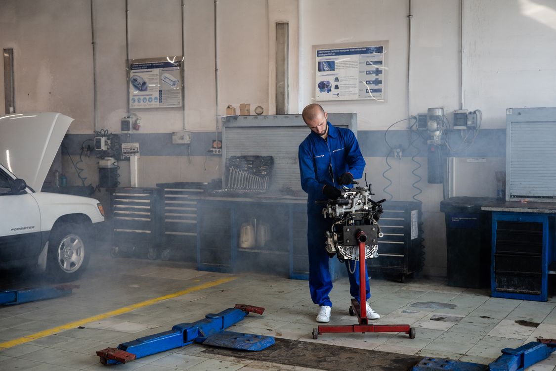 Mechanic working on car engine